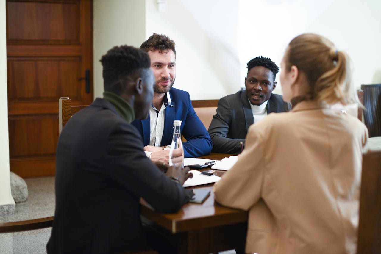 A diverse group of professionals having a business meeting around a table.